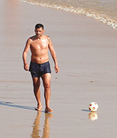 The Virgo with shirtless athletic body on the beach
